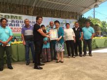 Dr. Luz Taposok in blue, receiving her certificate of appreciation from Kauswagan Mayor Rommel Arnado.