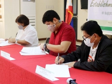 ATI and QC officials during the MOA signing for the establishment of Greenhouse Village